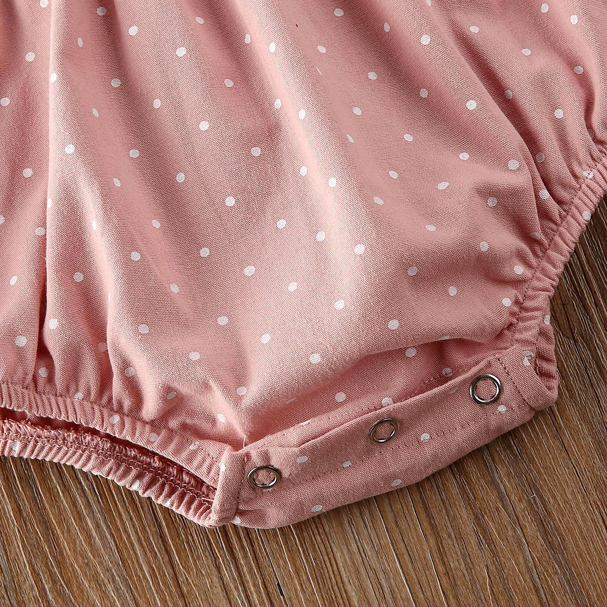 Niemowlęce body w kropeczki z długim rękawem i falbanką